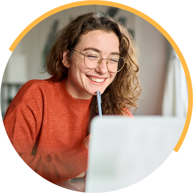 Smiling student using a laptop